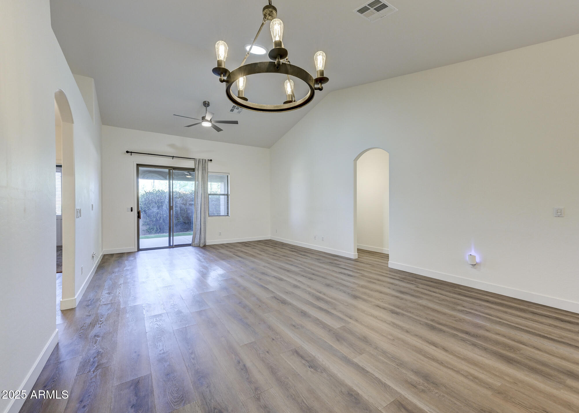 6646 East Rochelle Circle Mesa, AZ 85215 - Photo 7 of 43 a view of empty room with wooden floor and fan