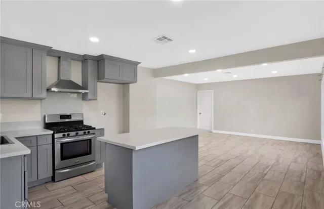 a kitchen with a sink a stove and refrigerator
