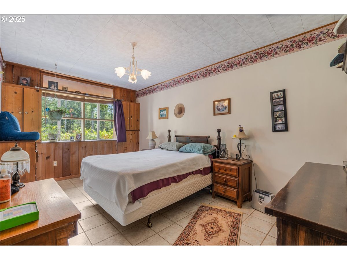 18175 Northeast Bald Peak Road Newberg, OR 97132 - Photo 23 of 41 a spacious bedroom with a large bed and a window
