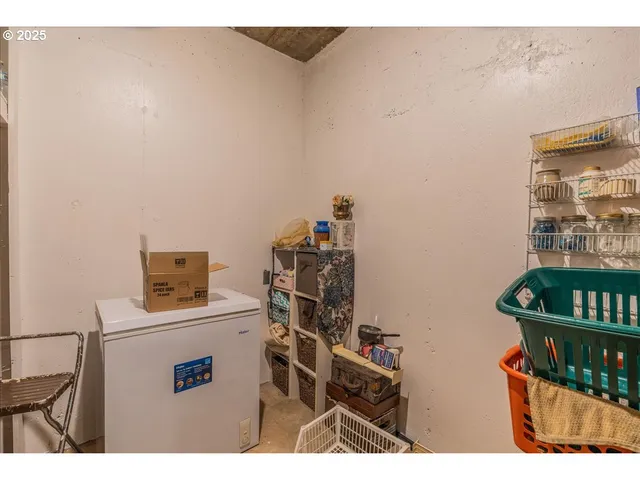 a utility room with dryer washer and a view of living room