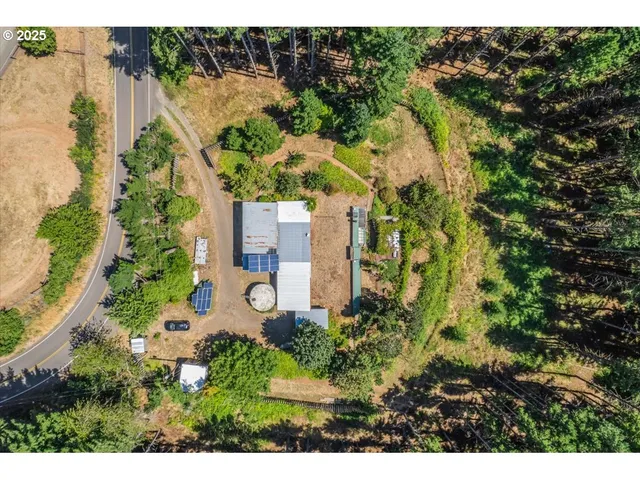a aerial view of a house with a yard swimming pool and outdoor seating