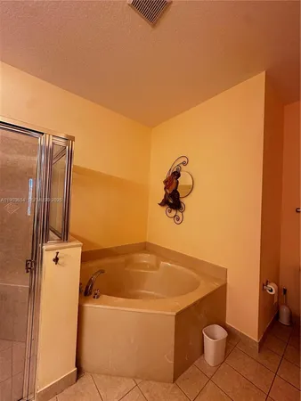 a bedroom with a bed window and lamp
