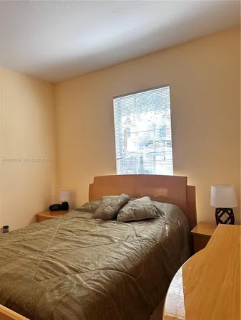 a bedroom with two beds and a window