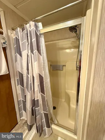 a bathroom with a shower and a glass door