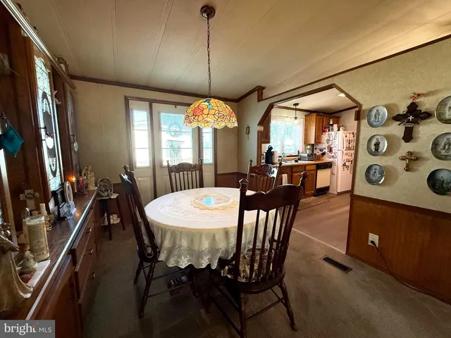 a view of a dining room with furniture and window