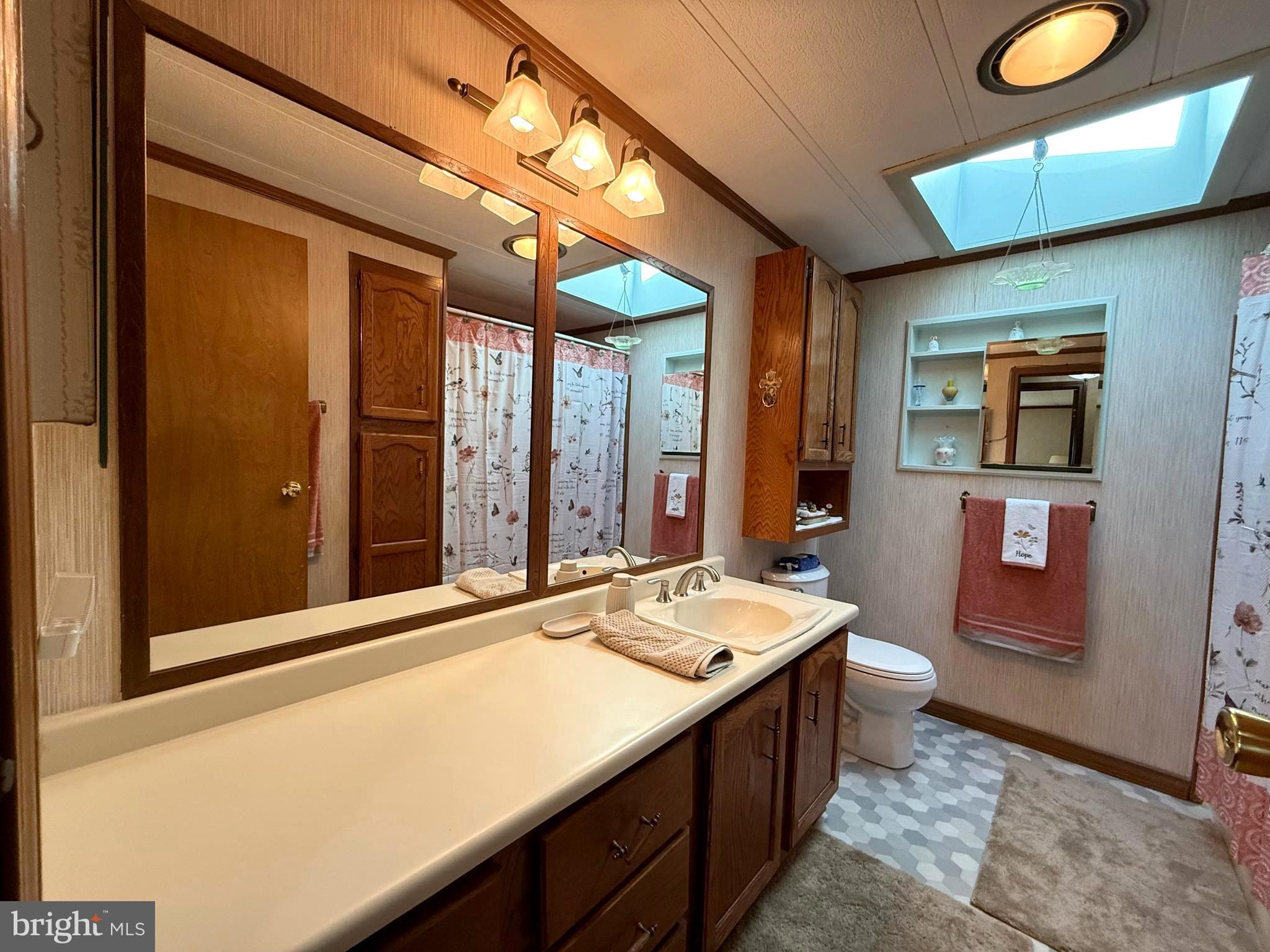 443 Priscilla Lane Buena, NJ 08310 - Photo 20 of 44 a bathroom with a sink a vanity and a large mirror