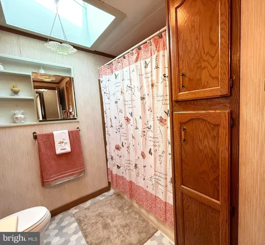 a bathroom with a toilet and shower