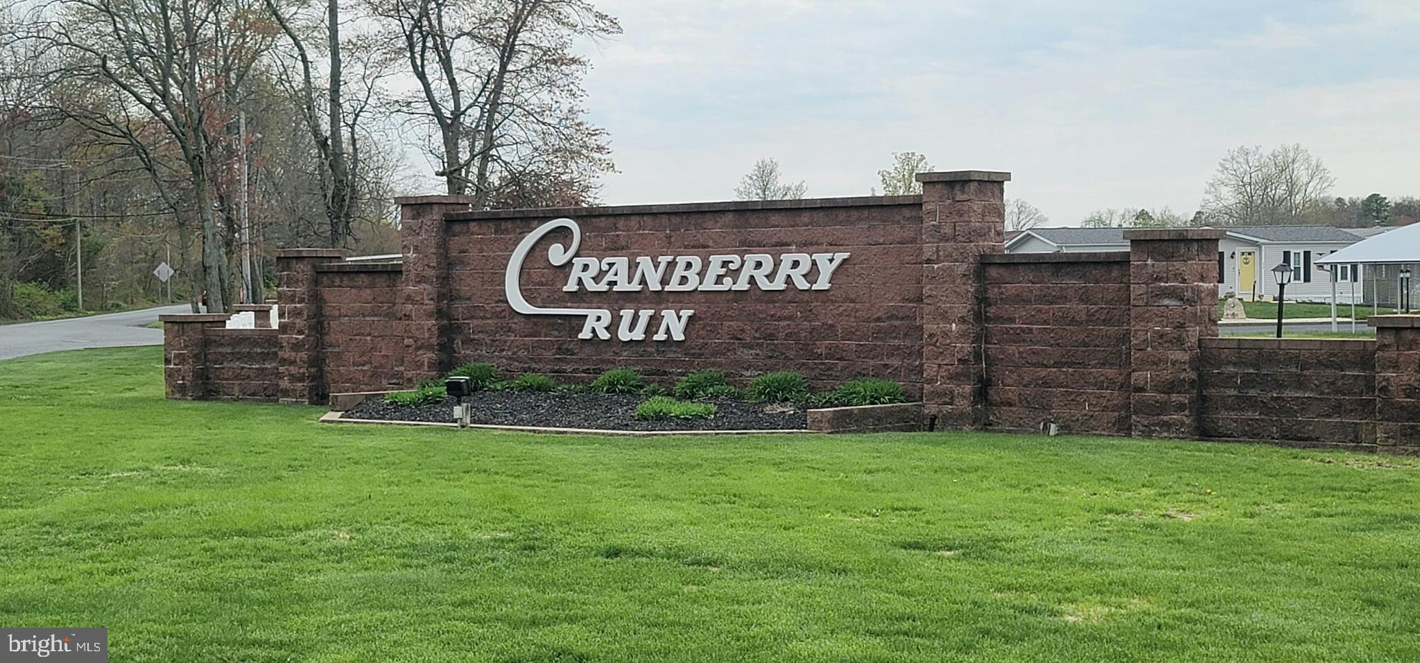 443 Priscilla Lane Buena, NJ 08310 - Photo 32 of 44 a view of a street sign under a large tree