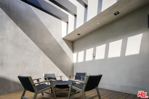 a bedroom with furniture and large window