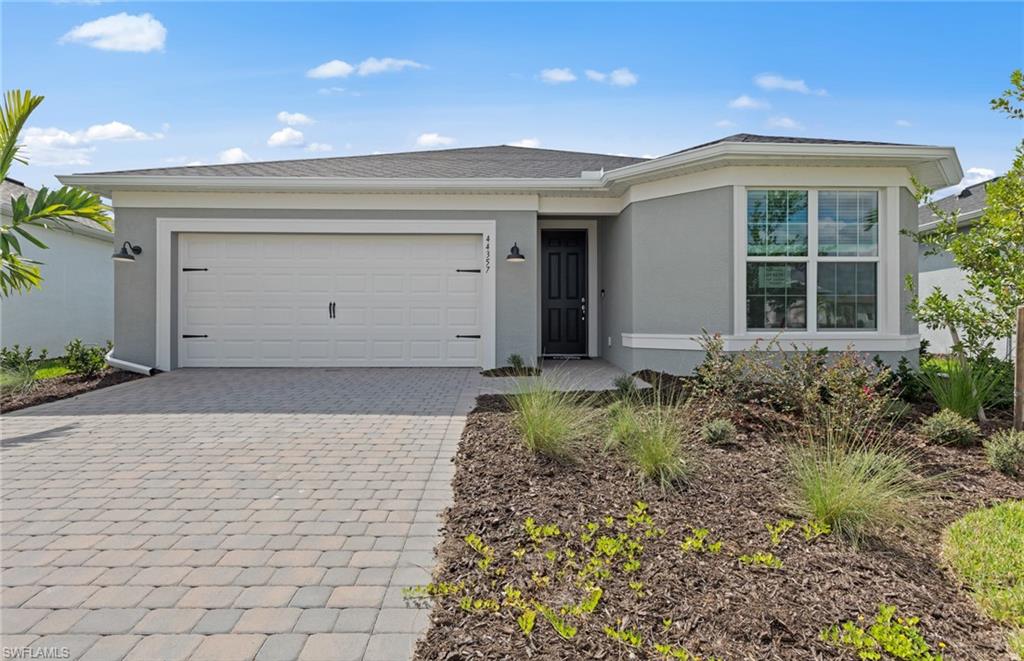 a front view of house with a garden