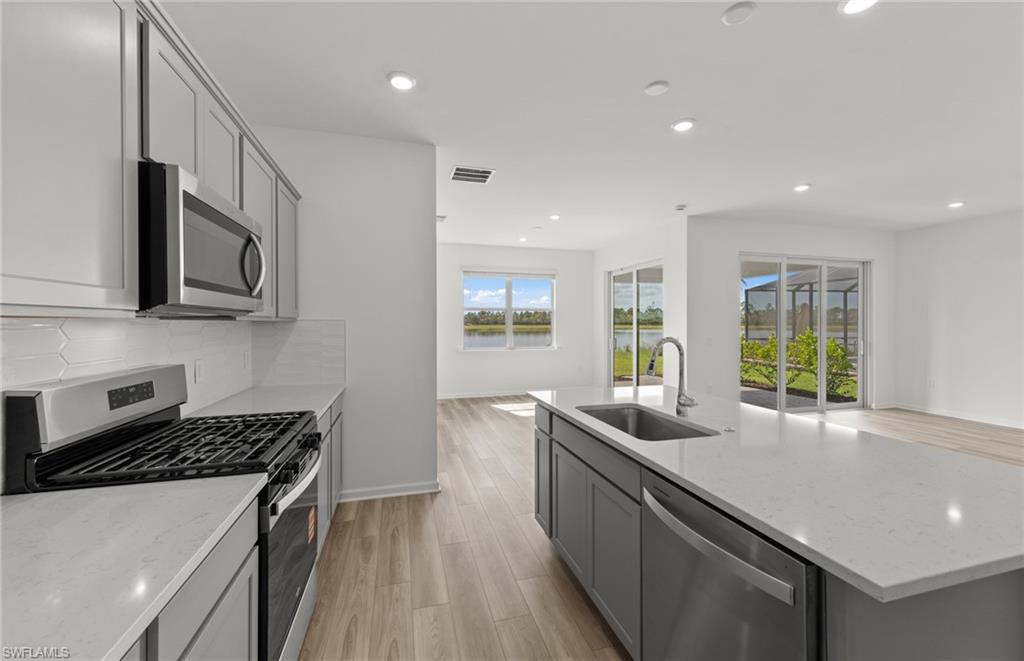 44357 Kelly Drive Punta Gorda, FL 33982 - Photo 5 of 24 a kitchen with stainless steel appliances granite countertop a sink and stove