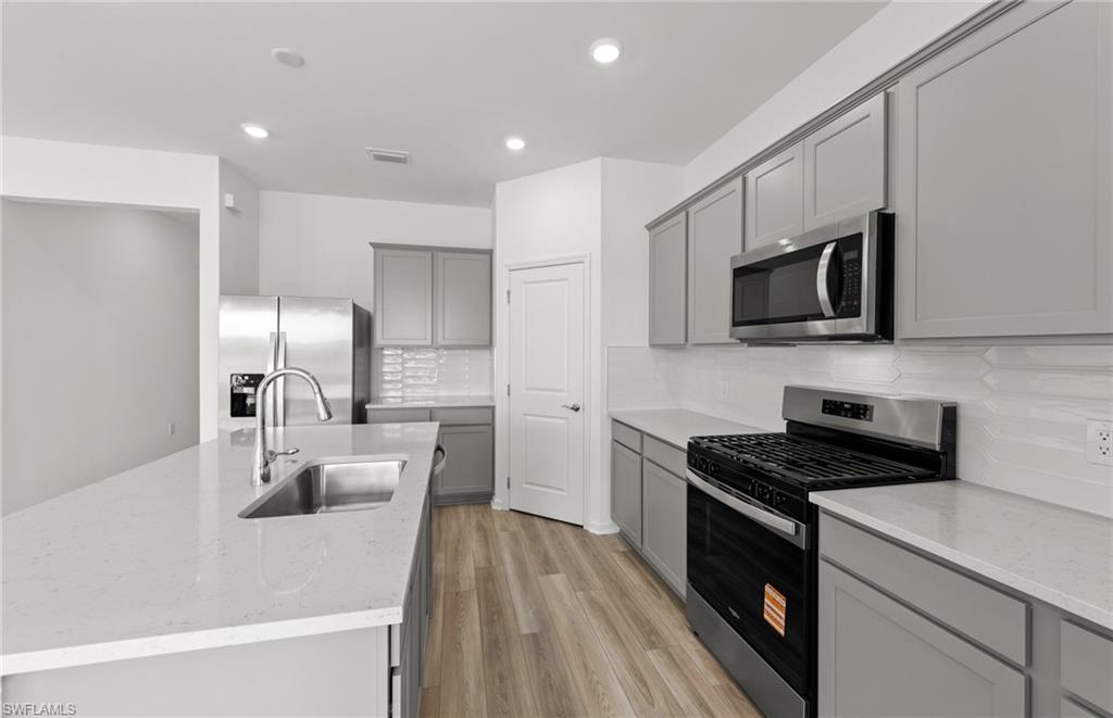 44357 Kelly Drive Punta Gorda, FL 33982 - Photo 6 of 24 a kitchen that has a sink and a stove top oven