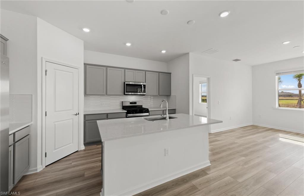 44357 Kelly Drive Punta Gorda, FL 33982 - Photo 7 of 24 a kitchen with stainless steel appliances a refrigerator sink and stove