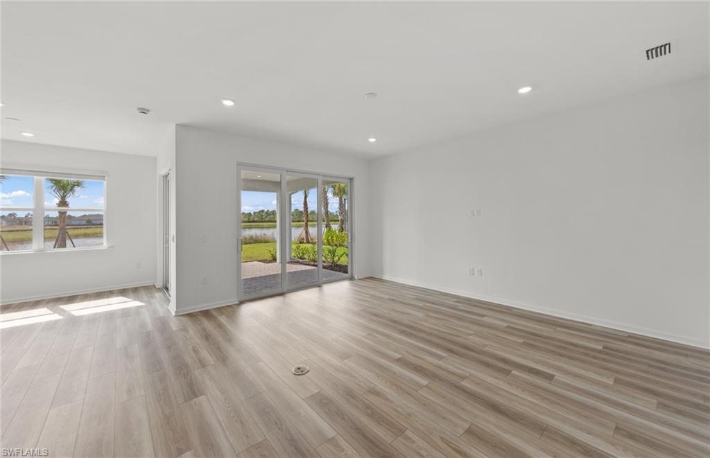 44357 Kelly Drive Punta Gorda, FL 33982 - Photo 10 of 24 wooden floor in an empty room with a window