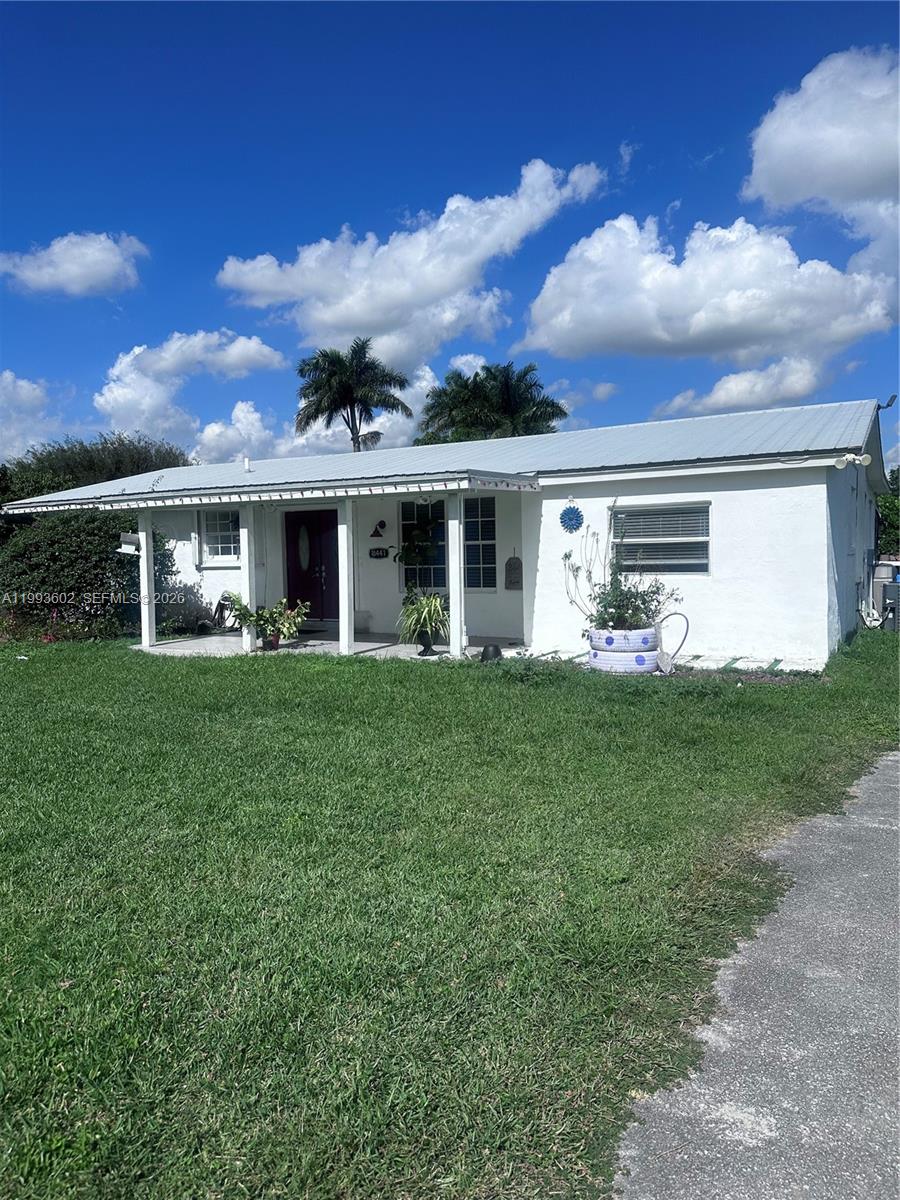 18441 Southwest 238th Street Homestead, FL 33031 - Photo 1 of 12 a front view of house with yard and green space