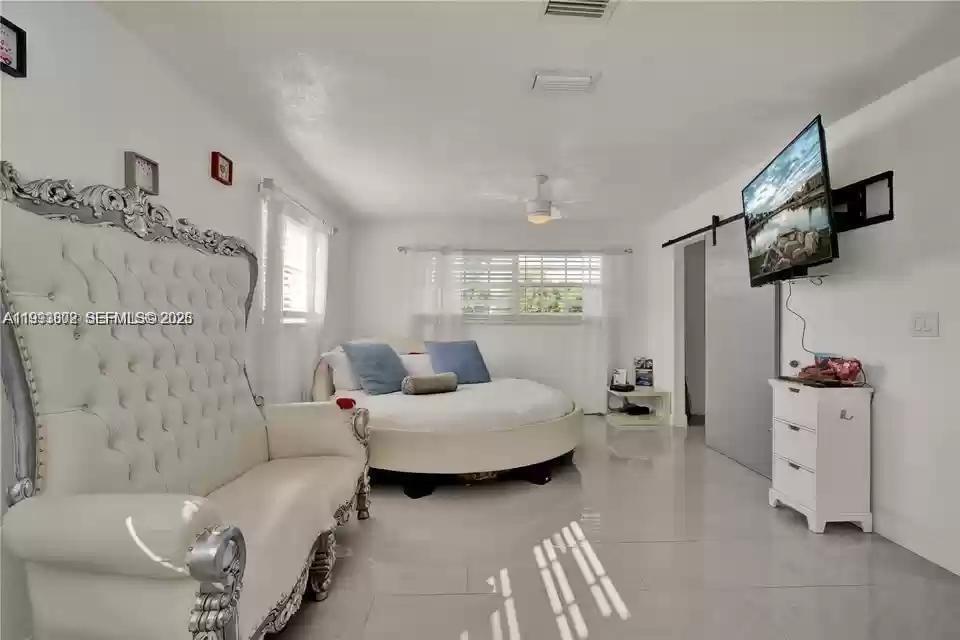 18441 Southwest 238th Street Homestead, FL 33031 - Photo 2 of 12 a living room with furniture and a flat screen tv