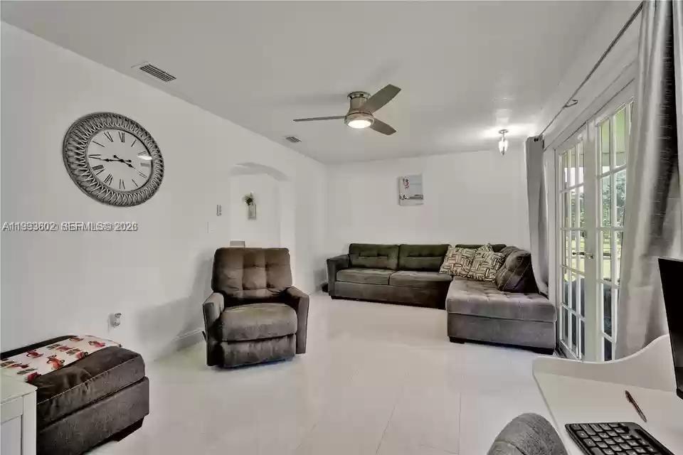 18441 Southwest 238th Street Homestead, FL 33031 - Photo 5 of 12 a living room with furniture and a window