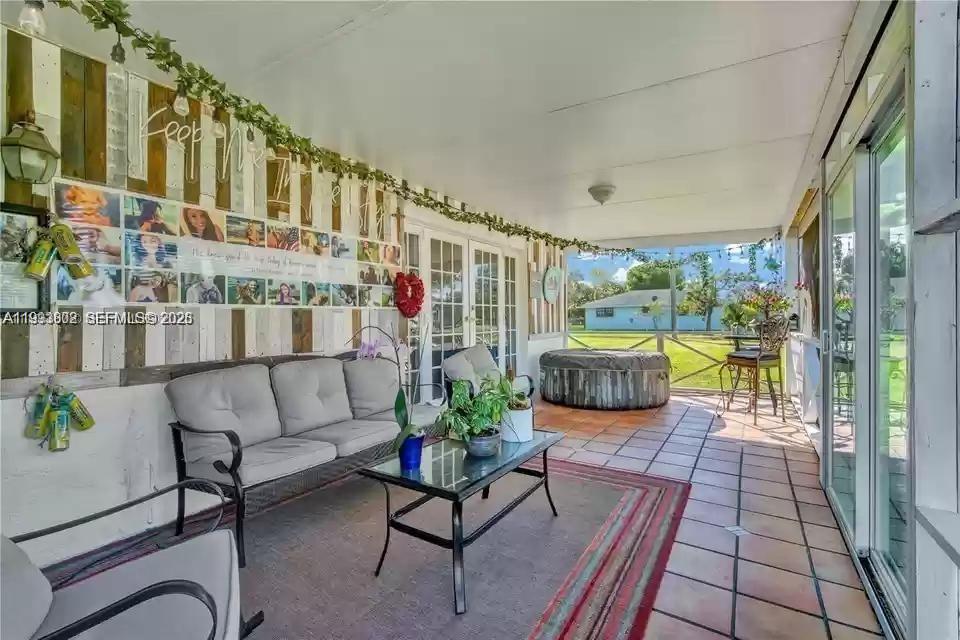 18441 Southwest 238th Street Homestead, FL 33031 - Photo 8 of 12 a balcony with furniture and a potted plant