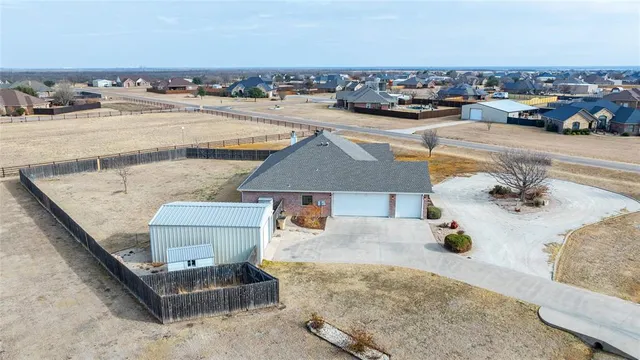 an aerial view of a house with a swimming pool and outdoor space