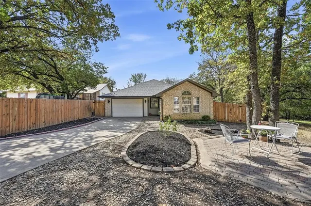a view of house with backyard and trees