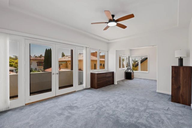 a living room with furniture and a ceiling fan