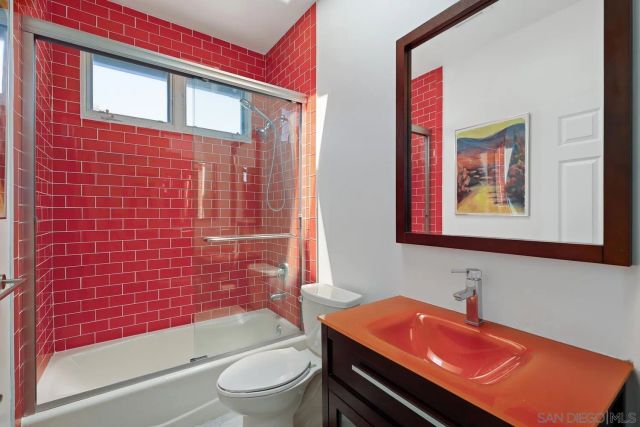 a bathroom with a toilet a sink and bathtub