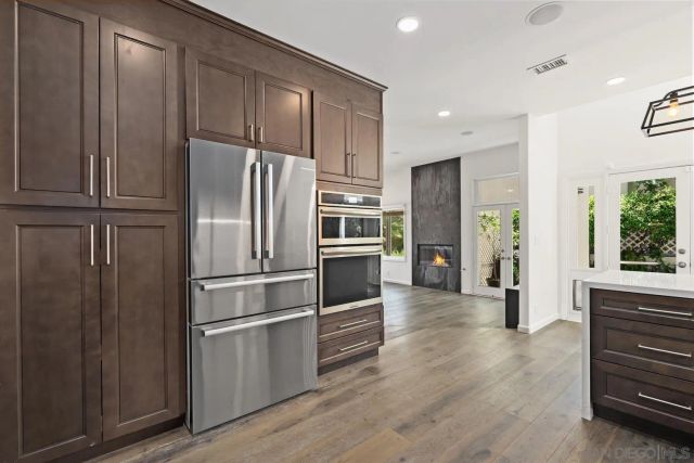 a kitchen with granite countertop stainless steel appliances and refrigerator
