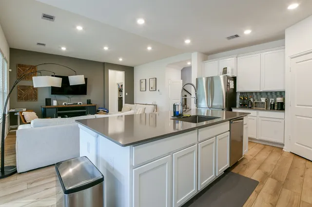 a kitchen with stainless steel appliances granite countertop a sink and a stove
