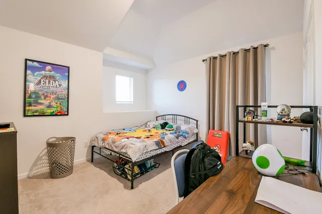 a bedroom with a bed and a dresser in it