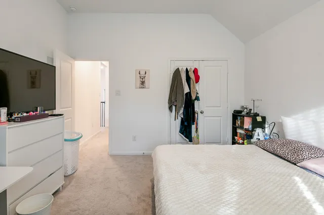 a bed room with a bed and a flat screen tv