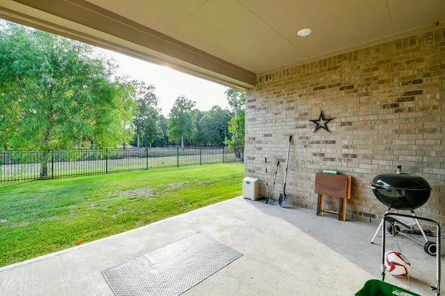 a view of a porch with furniture and garden