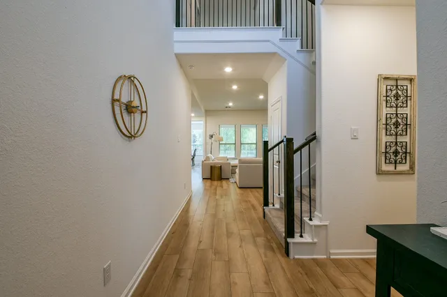 a view of a hallway with wooden floor