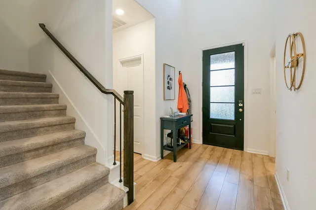 a view of an entryway with wooden floor