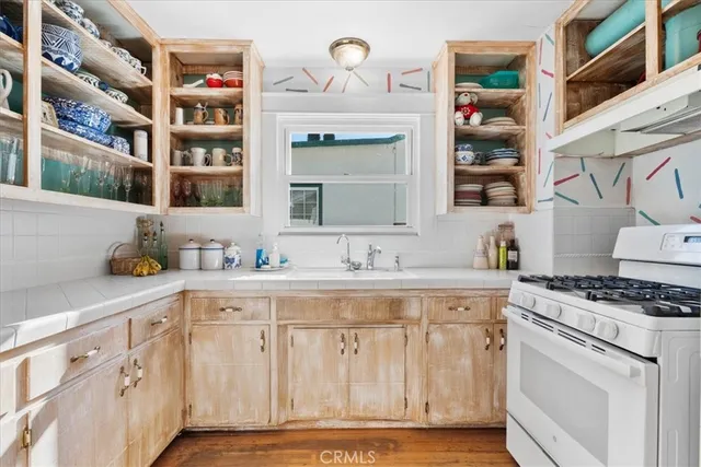 a kitchen with cabinets and window