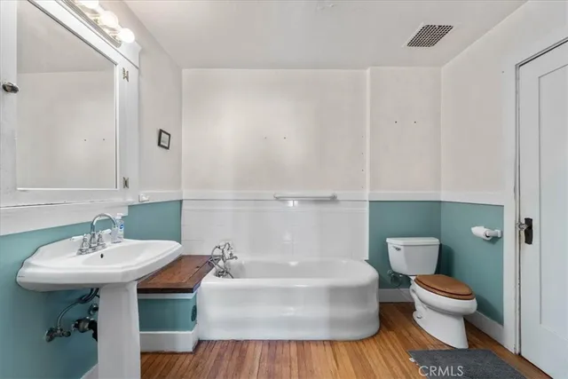 a bathroom with a sink a toilet and mirror