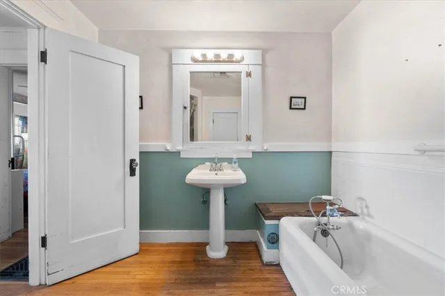 a bathroom with a sink a mirror and a bathtub