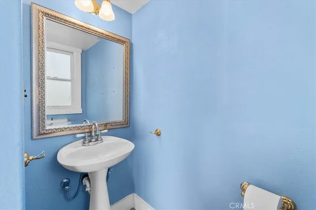 a bathroom with a sink a mirror and a toilet