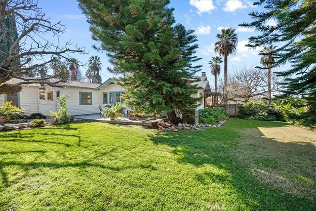 a view of backyard of house with green space