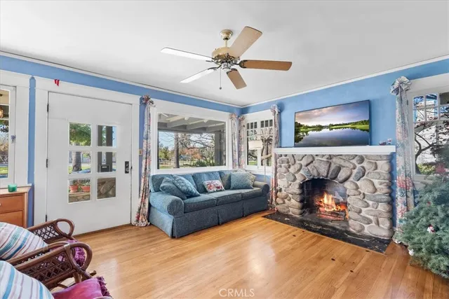 a living room with furniture fireplace and window