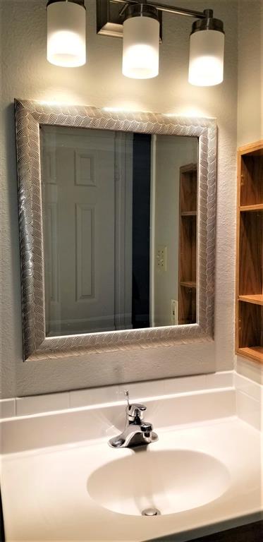2200 East Trinity Mills Road, Unit 403 Carrollton, TX 75006 - Photo 13 of 20 a bathroom with a sink and a mirror