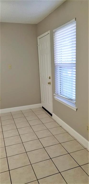 2200 East Trinity Mills Road, Unit 403 Carrollton, TX 75006 - Photo 15 of 20 a view of an empty room and window