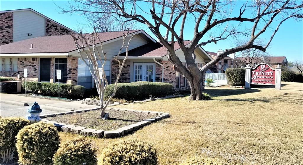 2200 East Trinity Mills Road, Unit 403 Carrollton, TX 75006 - Photo 3 of 20 a view of a white house with a yard covered in snow