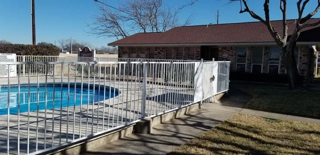 a view of balcony with wooden fence and potted plants