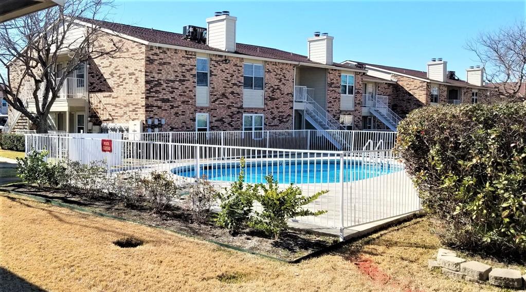 2200 East Trinity Mills Road, Unit 403 Carrollton, TX 75006 - Photo 5 of 20 a view of balcony with wooden fence and potted plants