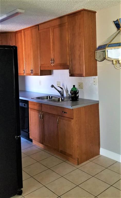 2200 East Trinity Mills Road, Unit 403 Carrollton, TX 75006 - Photo 7 of 20 a kitchen with stainless steel appliances granite countertop a refrigerator a sink and a stove