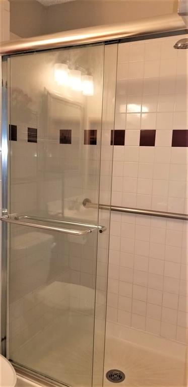 2200 East Trinity Mills Road, Unit 403 Carrollton, TX 75006 - Photo 10 of 20 a bathroom with a glass door shower