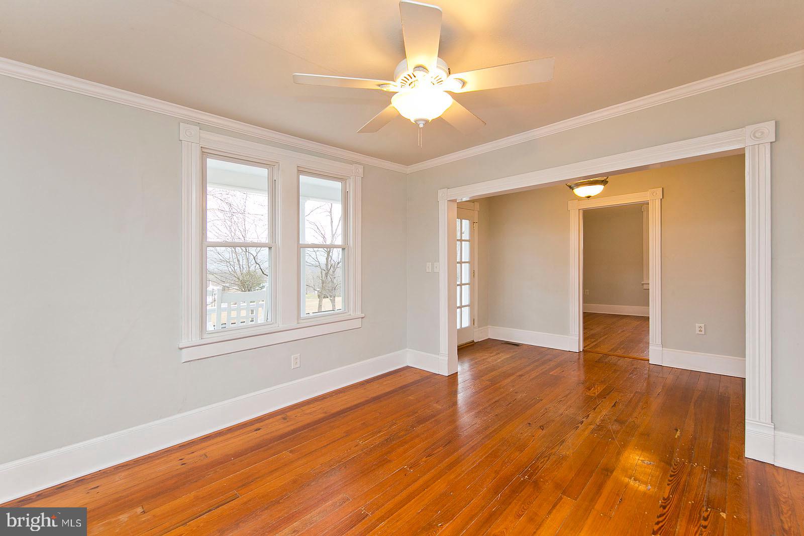 713 Rileyville Road Rileyville, VA 22650 - Photo 16 of 54 a view of an empty room with wooden floor and a window
