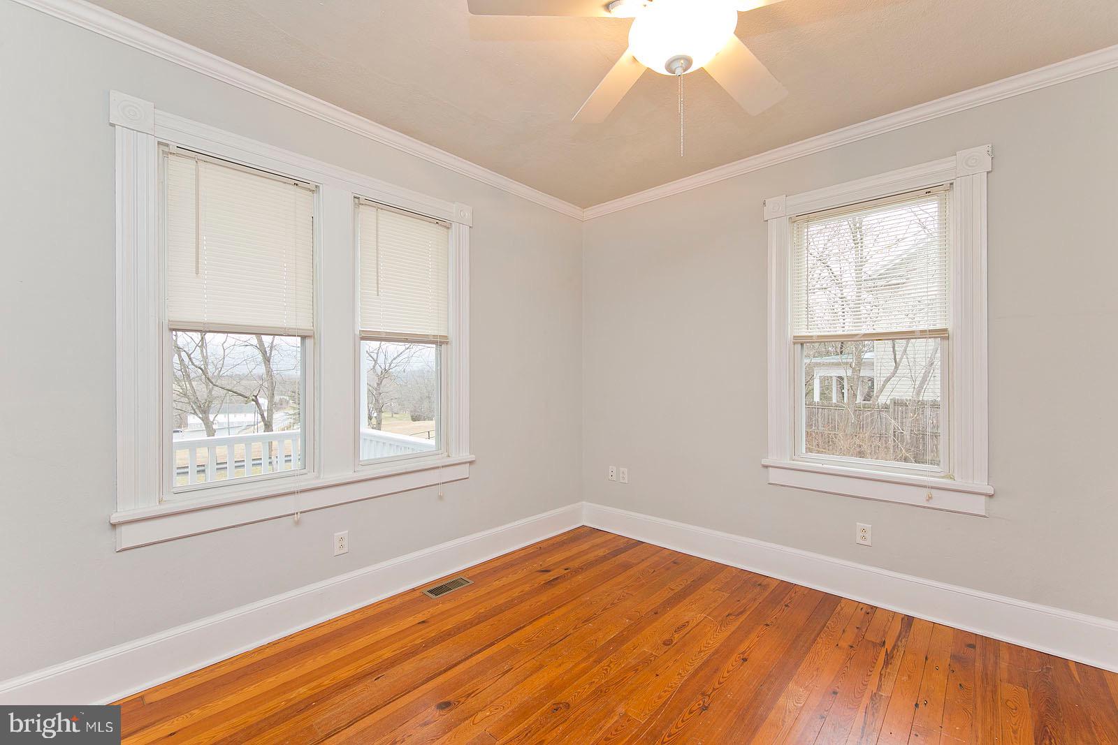 713 Rileyville Road Rileyville, VA 22650 - Photo 23 of 54 an empty room with wooden floor and windows