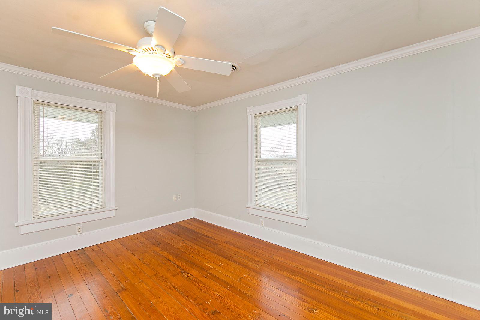 713 Rileyville Road Rileyville, VA 22650 - Photo 28 of 54 an empty room with wooden floor and windows