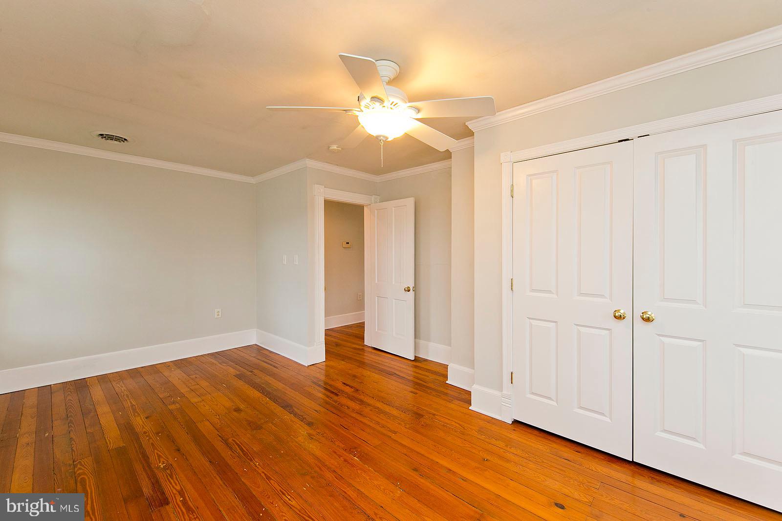 713 Rileyville Road Rileyville, VA 22650 - Photo 30 of 54 a view of empty room with wooden floor and fan